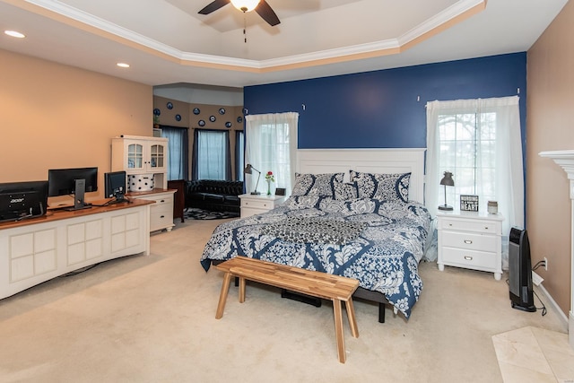 carpeted bedroom featuring a raised ceiling, ceiling fan, and crown molding