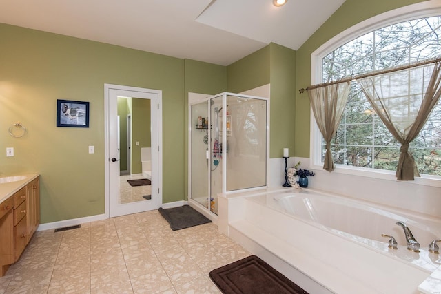 bathroom with plus walk in shower, vanity, and tile patterned floors