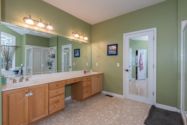 bathroom featuring vanity and a shower with door