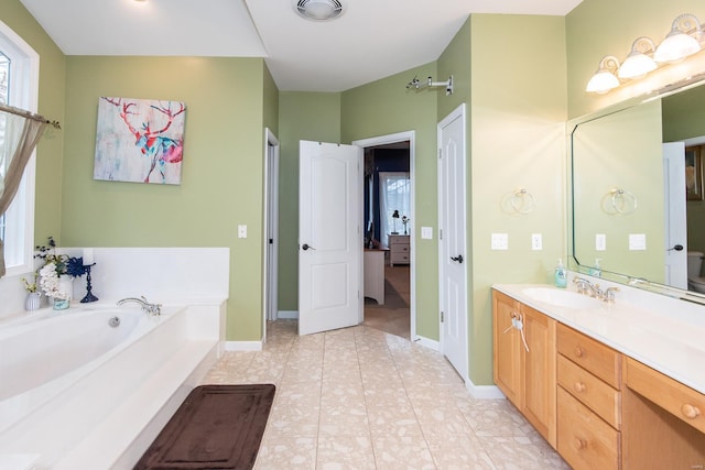 bathroom with tile patterned flooring, vanity, and a bathing tub