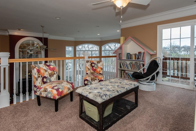 sitting room with a wealth of natural light, carpet, and ornamental molding