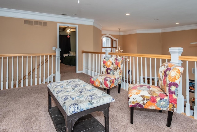 sitting room featuring carpet floors and crown molding