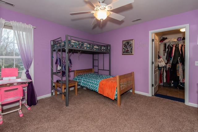 carpeted bedroom featuring ceiling fan and a closet