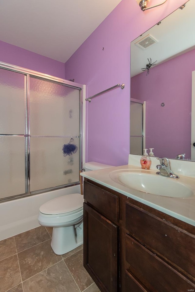 full bathroom with shower / bath combination with glass door, vanity, and toilet