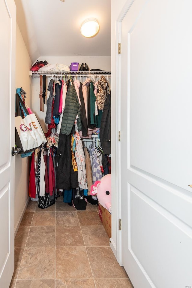 walk in closet with lofted ceiling