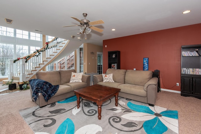 carpeted living room with ceiling fan