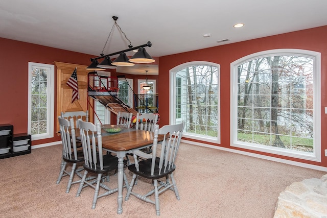 carpeted dining area featuring a healthy amount of sunlight