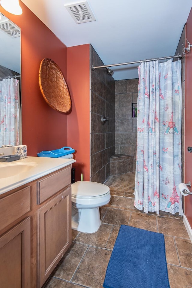 bathroom with a shower with curtain, vanity, and toilet