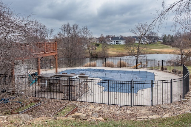 view of swimming pool with a water view and a patio area