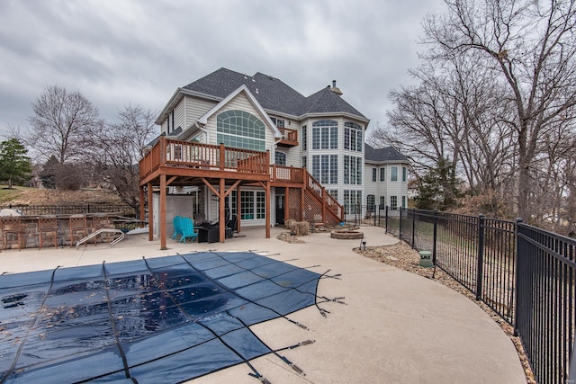 back of house featuring a patio and a pool side deck