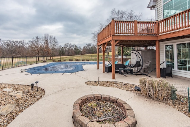 view of swimming pool featuring a patio area, an outdoor fire pit, and a wooden deck