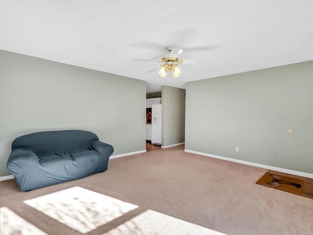 living area featuring light carpet and ceiling fan