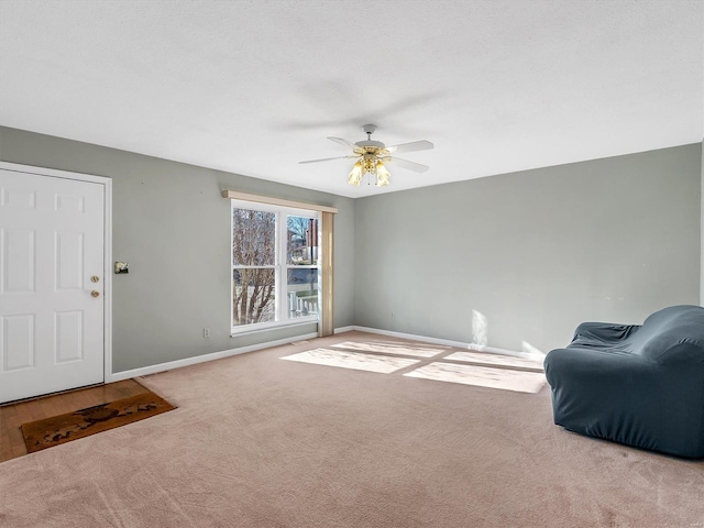 interior space with carpet flooring and ceiling fan