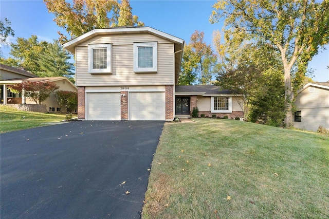 view of front of property featuring a garage and a front lawn