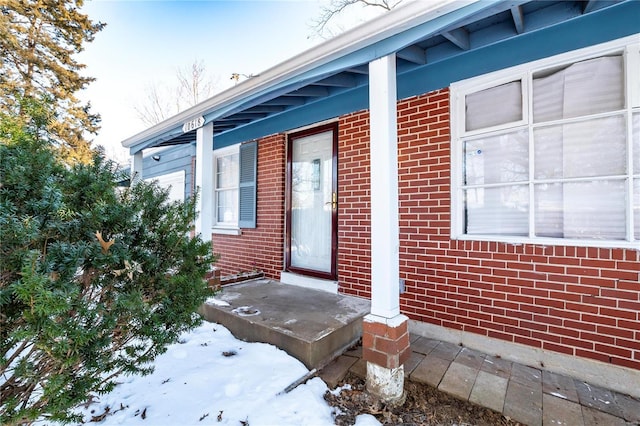 view of snow covered property entrance