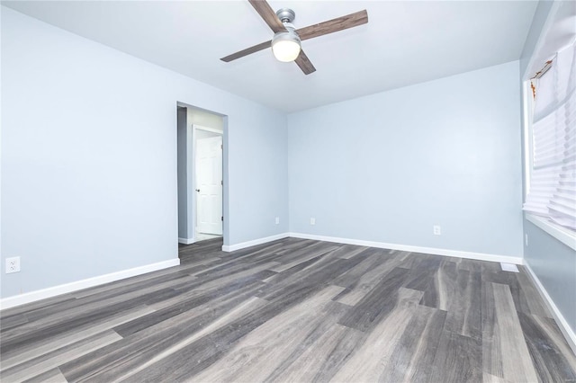 empty room featuring dark hardwood / wood-style flooring and ceiling fan