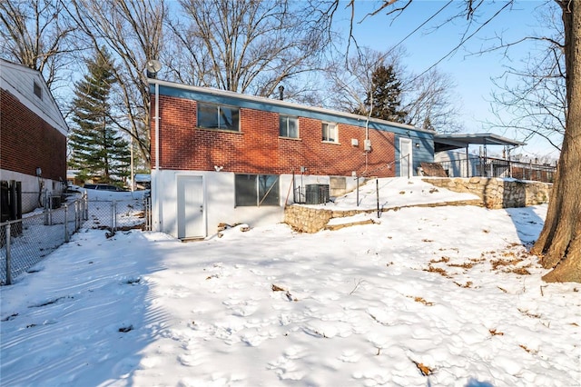 snow covered property featuring cooling unit