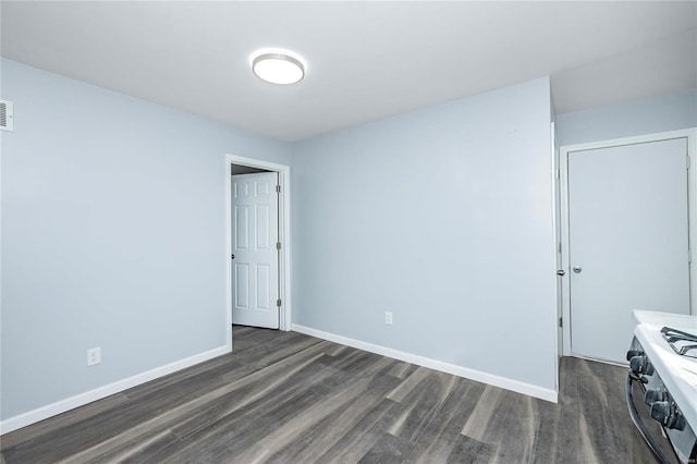 empty room featuring dark hardwood / wood-style floors