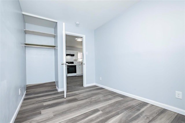 unfurnished bedroom with a closet and wood-type flooring