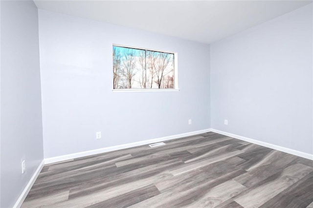 spare room featuring wood-type flooring