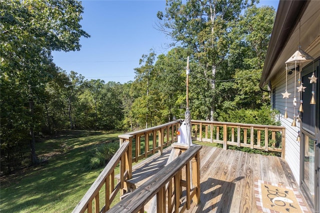 wooden terrace featuring a yard