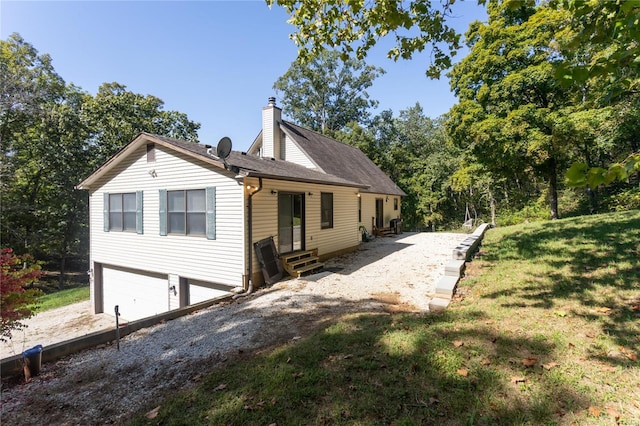 view of front of property featuring a garage and a front lawn