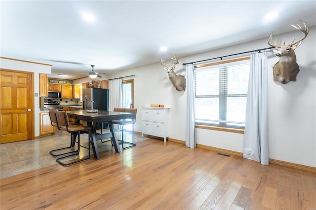 kitchen with appliances with stainless steel finishes and light hardwood / wood-style flooring