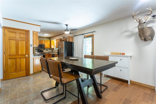 dining room featuring ceiling fan and sink