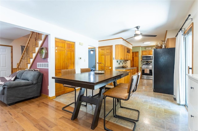 kitchen featuring appliances with stainless steel finishes, light hardwood / wood-style floors, and ceiling fan