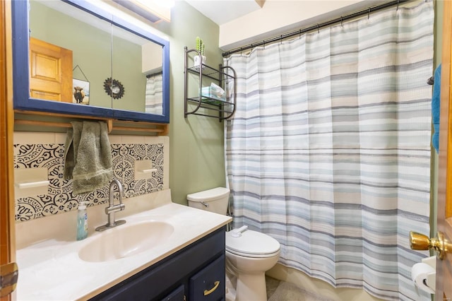 bathroom with vanity, backsplash, and toilet