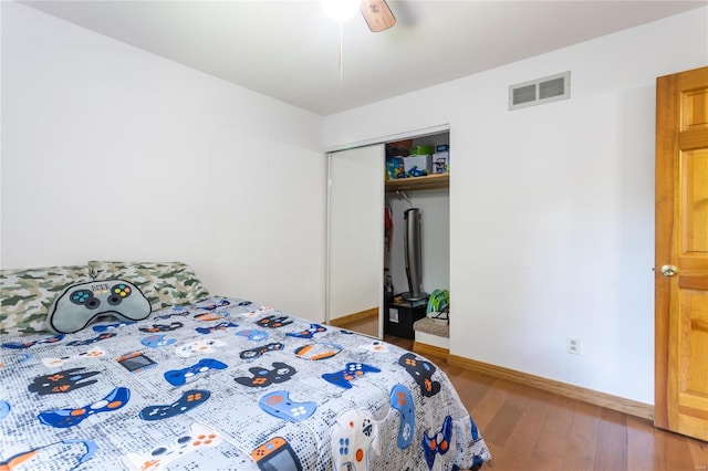 bedroom featuring wood-type flooring, a closet, and ceiling fan