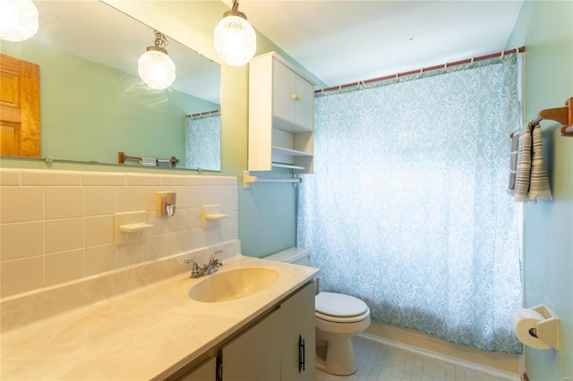 bathroom featuring tasteful backsplash, vanity, tile walls, and toilet