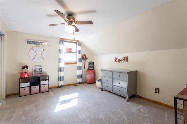 interior space with ceiling fan, light colored carpet, and vaulted ceiling