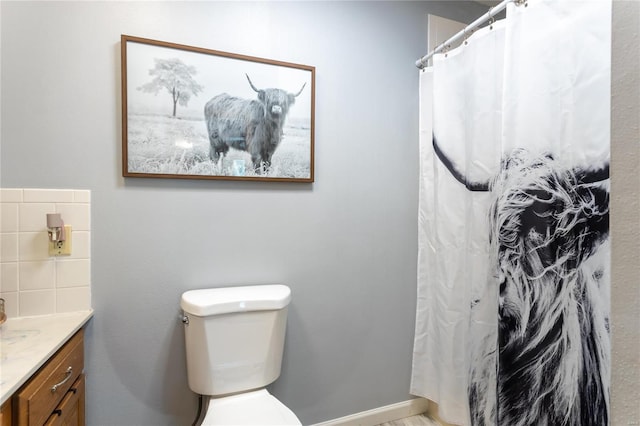 bathroom featuring backsplash, vanity, a shower with shower curtain, and toilet