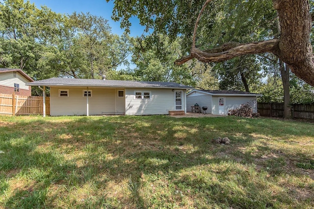 rear view of property featuring a lawn