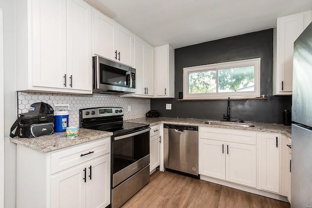 kitchen with white cabinetry and stainless steel appliances