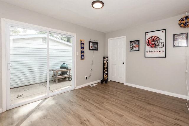 unfurnished room with hardwood / wood-style floors