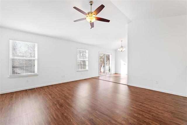 interior space featuring dark hardwood / wood-style floors, ceiling fan with notable chandelier, and a wealth of natural light