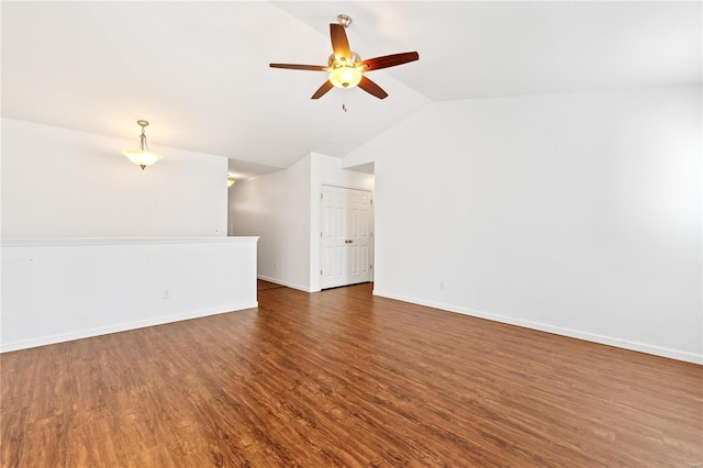 unfurnished living room featuring dark hardwood / wood-style flooring, vaulted ceiling, and ceiling fan