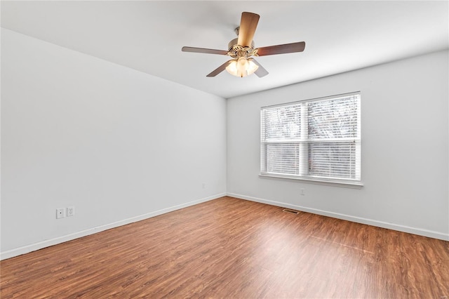 spare room featuring hardwood / wood-style flooring and ceiling fan