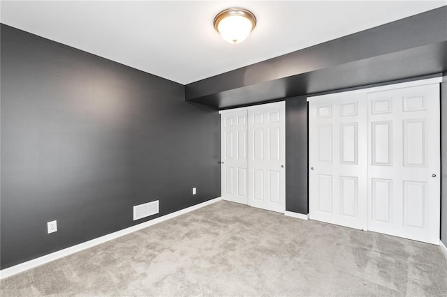 unfurnished bedroom featuring light carpet