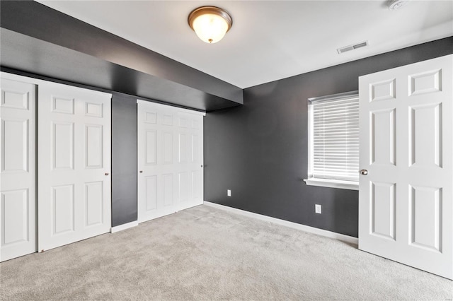 unfurnished bedroom featuring light carpet