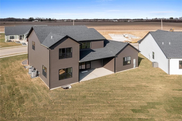 rear view of house with a patio area and a lawn