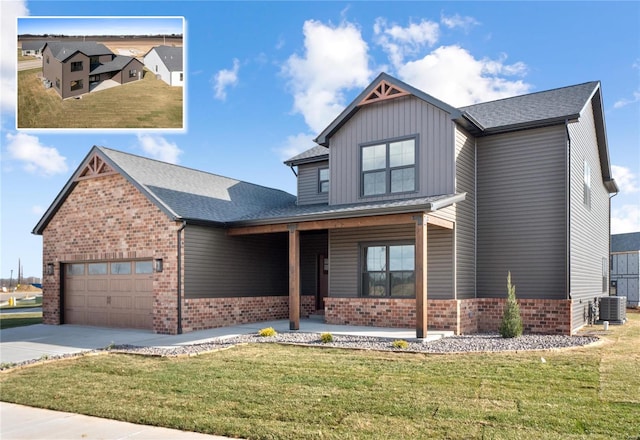 view of front of house featuring a garage, a front lawn, and central air condition unit