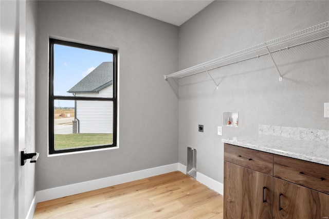 laundry area featuring electric dryer hookup, washer hookup, and light hardwood / wood-style flooring