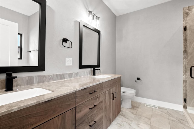 bathroom featuring vanity, toilet, and an enclosed shower