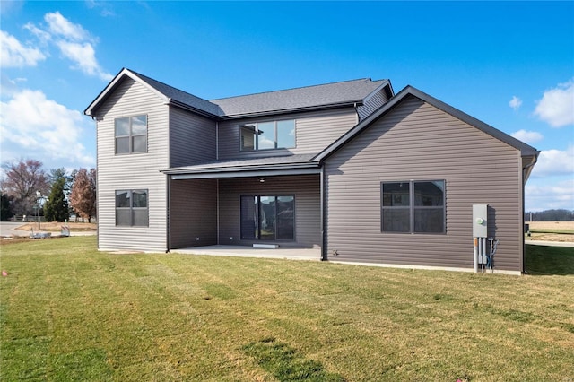 rear view of property with a lawn and a patio