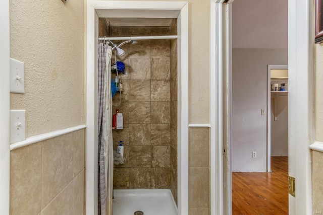 bathroom with a shower with curtain and wood-type flooring