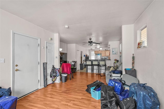 living room with ceiling fan and light hardwood / wood-style floors