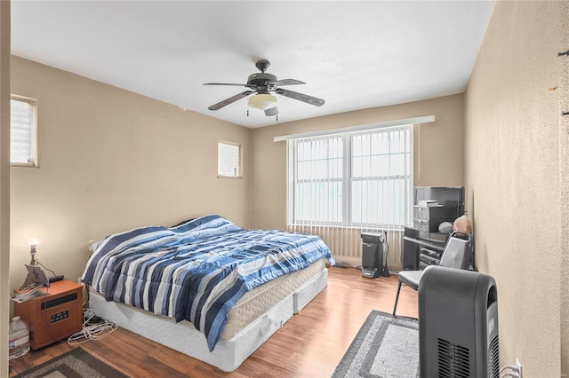 bedroom featuring hardwood / wood-style flooring and ceiling fan